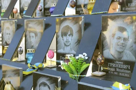 Blessed Easter breads are placed in front of portraits of protesters killed.. Stock Photos