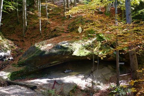 Blessed Stone and sacred spring in forest near Manyava Skete in Ukraine Fotos de archivo