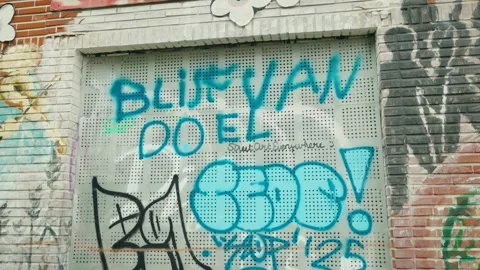 "Blijf van Doel" (Don't touch Doel) graffiti message on boarded window in Stock Footage 340935926
