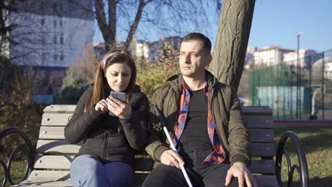 Blind man and his wife sitting on a park... | Stock Video | Pond5