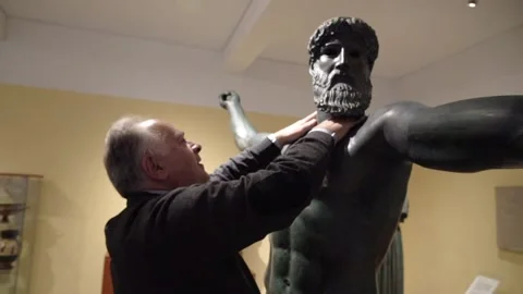 Blind man touching copy of Zeus statue - slow motion Stock Footage 140989785