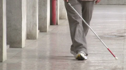 Blind man walking with his white cane for the street Stock Footage