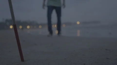 Blind Man walking towards the cane on a beach. 動画素材 90610806