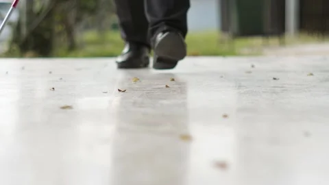 Blind man walking with white cane Stock Footage 148652739
