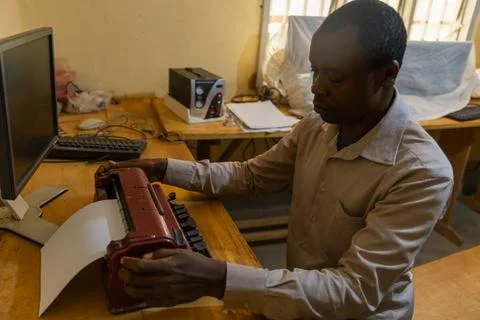 A blind person during typing work on a special braille typewriter Stock Photos