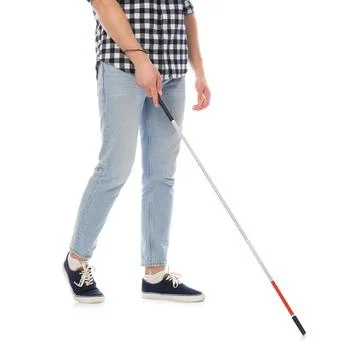 Young blind person with long cane walking on white background