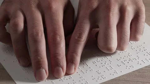 Blind Person Using Fingers to Read a Braille Text Closeup 스톡 동영상 164413868