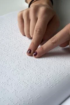 Blind reading text in braille language Stock Photos