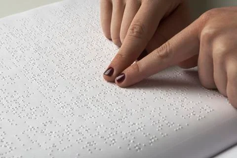 Blind reading text in braille language Stock Photos