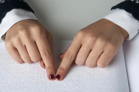 Blind reading text in braille language Stock Photos