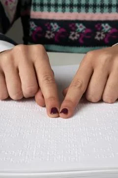 Blind reading text in braille language Stock Photos