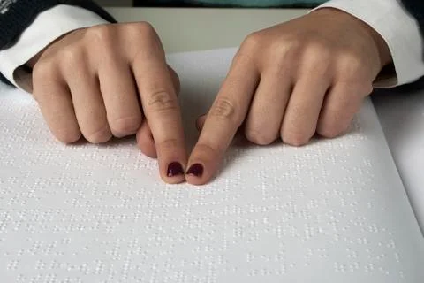 Blind reading text in braille language Stock Photos