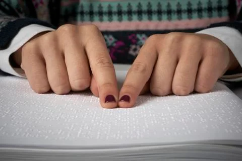 Blind reading text in braille language Stock Photos