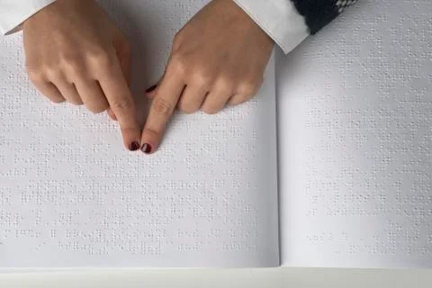 Blind reading text in braille language Stock Photos