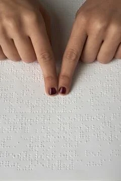 Blind reading text in braille language Stock Photos