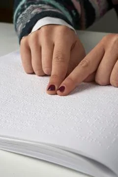Blind reading text in braille language Stock Photos