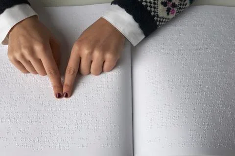 Blind reading text in braille language Stock Photos