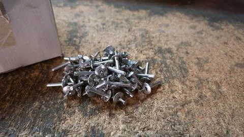 Blind rivets on a table in the workshop or warehouse Stock Photos