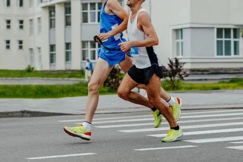 Blind runner with his guide running city marathon Stock Photos
