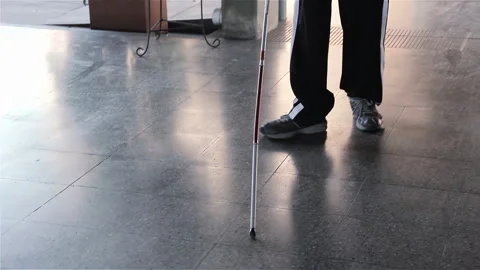 A Blind Student Using His Cane As He Walks Down the Hallway of A School. 4K. Stock Footage 265192033