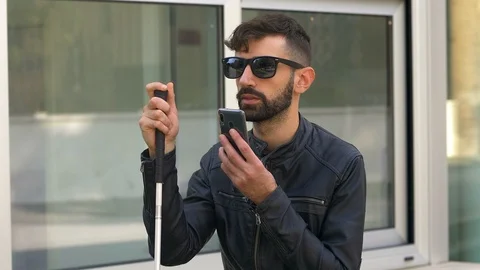 Blind young man using smartphone in the city.technology,handicap, help Stock Footage 120520178
