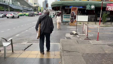 Blinded old man walk on footpath using white cane, holding wooden lottery ticket Video stock 172359058