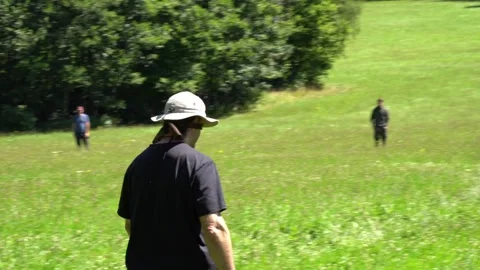 Blindfold navigation drill across open grassland to reveal natural left-right Stock Footage 331493995