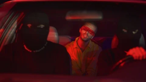 Blindfolded man is kidnapped and driven in backseat of car Stock Footage 109273477