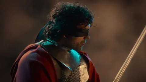 Blindfolded Man in Medieval Armor Wielding Sword in Combat Stock Footage 345514792