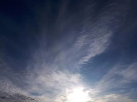 The blinding glare of the sun behind the clouds Stock Photos