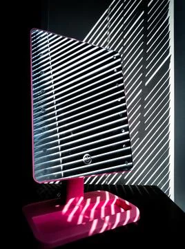 The blinds are reflected in the mirror Stock Photos