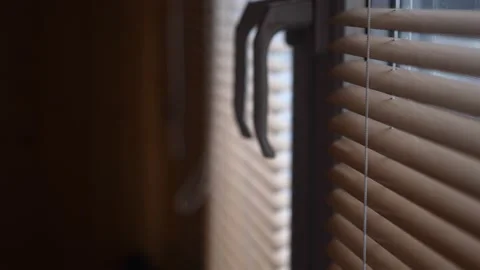 The blinds open slowly and sunlight enters the room Stock Footage 149021560