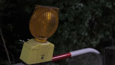 Blinking and flashing yellow warning light near construction zones at night Stock Footage 229009970