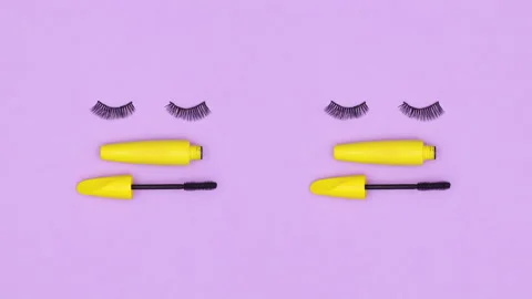 Blinking artificial eye lashes with yellow mascara on purple theme. Stop motion 스톡 동영상 166218726