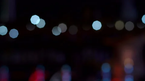 Blinking blurred lights in the dark in a restaurant or cafe. Slow motion. Stock Footage 100824747