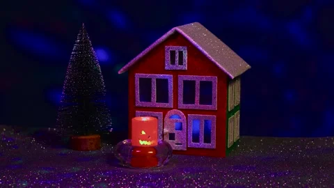 Blinking candle in front of a house and a Christmas tree Stock Footage 288284441