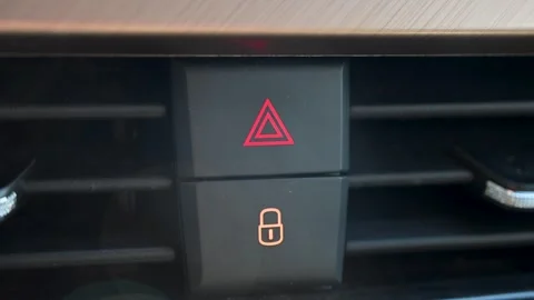 Blinking car hazard light button nest to door lock button. Stock Footage 339481202