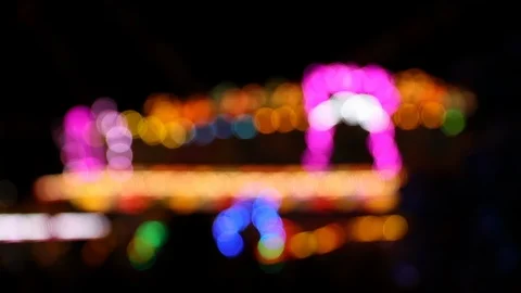 Blinking defocused lights of carnival attraction at night Stock Footage 124523914