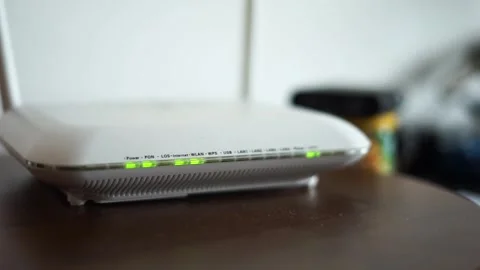 Blinking green lights on white dusty internet router Stock Footage 312100609
