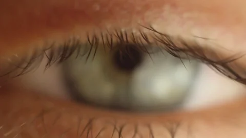 Blinking male eye close-up looking around. red artery on the eyeball macro Stock Footage 108580423