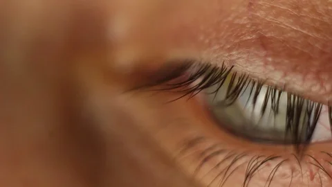 Blinking male eye close-up looking around. red artery on the eyeball macro Stock Footage 108617245