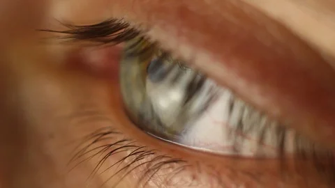 Blinking male eye close-up looking around. red artery on the eyeball macro Stock Footage 108617309