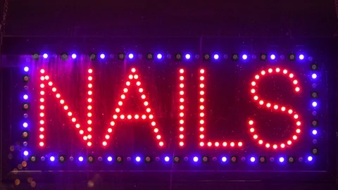 Blinking nails  Neon sign in window of beauty shop Stock Footage 100358158