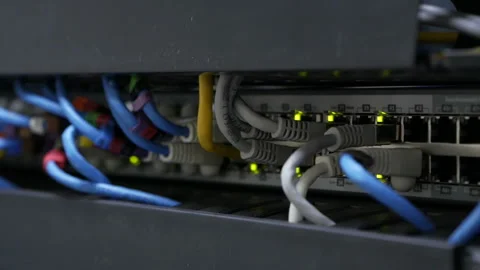 Blinking network ethernet active switch with connected cables in server room. Stock Footage 113613311