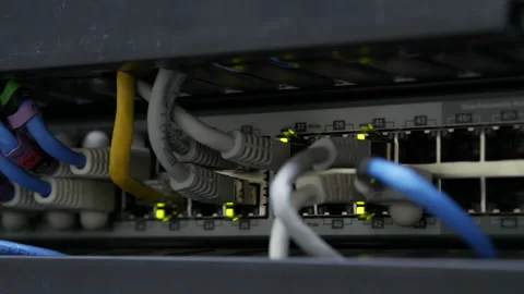 Blinking network ethernet active switch with connected cables in server room. Video stock 113613336