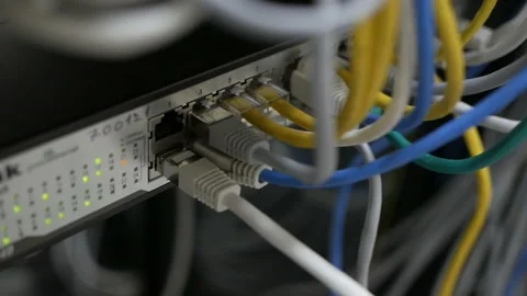 Blinking network ethernet active switch with connected cables in server room. Video stock 114492605