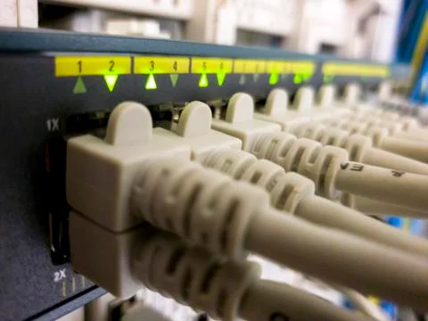 Blinking network ethernet active switch with connected cables in server room Stock Photos