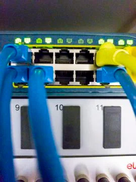 Blinking network ethernet active switch with connected cables in server room Stock Photos