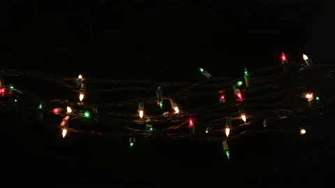 Blinking red, white and green small bulb string lights on black Stock Footage 201631378