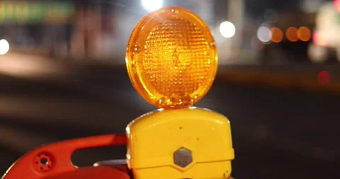 Blinking top light of a construction cone deviating the traffic Stock Footage 156940033